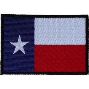 May include: A blue, white, and red embroidered patch with a white star in the blue section. The patch has a black border.