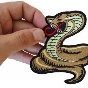 May include: A brown and black embroidered iron-on patch of a cobra snake with a red tongue. The snake is in a coiled position with its head raised and fangs bared.