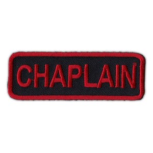 May include: Red embroidered patch with a black background and the word "CHAPLAIN" in red.