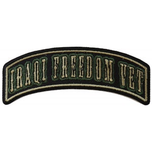 May include: Black and tan embroidered patch with the text "IRAQI FREEDOM VET" in green and tan lettering.