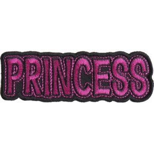 May include: Pink embroidered iron-on patch with the word "PRINCESS" in a bold, outlined font.