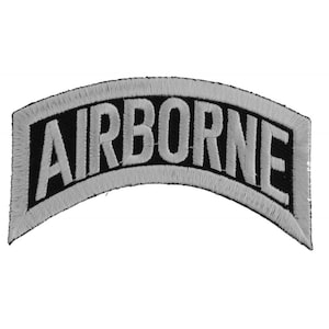 May include: A white embroidered patch with the word "AIRBORNE" in black lettering. The patch is curved and has a gray border.