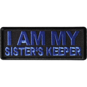 May include: Black embroidered patch with blue text that reads "I AM MY SISTER'S KEEPER".