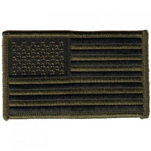 May include: Embroidered patch featuring the American flag in olive green and black. The flag design includes stars in the upper left corner and horizontal stripes. The patch has a stitched border.