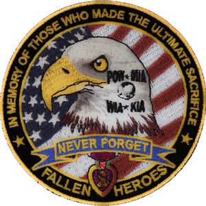 May include: A black and gold embroidered patch with an American flag, a bald eagle, and the text "In memory of those who made the ultimate sacrifice.  Never forget. Fallen heroes."  The eagle has the text "POW MIA" and "WIA KIA" on its chest.