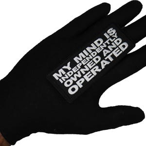 May include: Black glove with a white patch that says "My Mind Is Independently Owned And Operated."