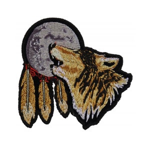 May include: Embroidered patch featuring a wolf howling at a dreamcatcher with brown feathers and a red and white beaded design.