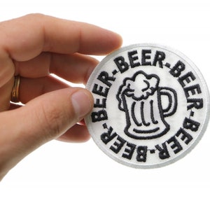 May include: White embroidered patch with a black outline of a beer mug and the text "Beer-Beer-Beer-Beer" around the mug.