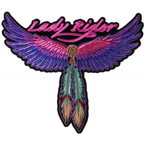 May include: Embroidered patch with a pair of pink and purple wings with a dreamcatcher and feathers hanging from the center. The text "Lady Rider" is written in pink cursive above the wings.