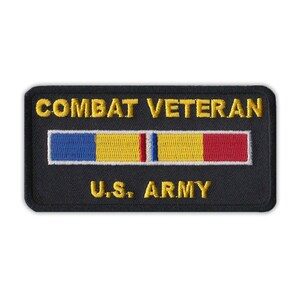 May include: Black embroidered patch with gold lettering that reads "Combat Veteran U.S. Army". A yellow, red, blue, and white ribbon is centered above the text.