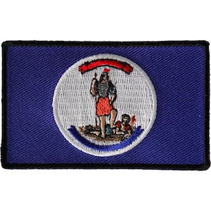 May include: An embroidered patch featuring the state flag of Virginia. The patch is blue with a white circle containing a red and white image of a man standing on a hill with a spear and a child kneeling at his feet. The circle is surrounded by a white border and a red ribbon.