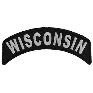May include: Black and white embroidered patch with the word "WISCONSIN" in white lettering on a black background. The patch is shaped like a curved banner.