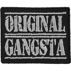 May include: Black embroidered patch with white text that reads "ORIGINAL GANGSTA'"