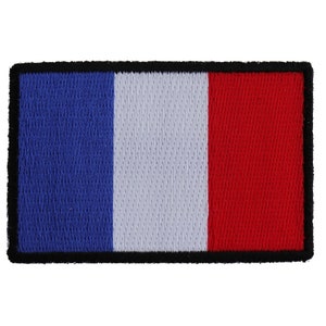 May include: A blue, white, and red embroidered patch with a black border. The patch features the colors of the French flag.