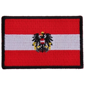 May include: Embroidered patch featuring the flag of Austria. The rectangular patch has a red background with a white horizontal stripe in the center. The Austrian coat of arms is centered on the white stripe, and the patch is bordered in black.