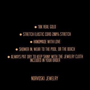 May include: A black background with gold text describing the features of a jewelry piece. The text reads: "18K Real Gold", "Stretch Elastic Cord 200% Stretch", "Handmade with Love", "Shower in, wear to the pool, or the beach", "Always pat dry to keep shiny with the jewelry cloth included in your order", and "Norvoski Jewelry".