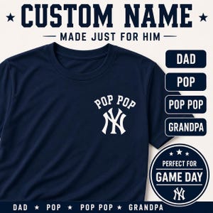 May include: A navy blue t-shirt featuring a white graphic on the chest with the text POP POP above a stylized NY logo. The image includes text options DAD, POP, POP POP, and GRANDPA, along with the text CUSTOM NAME MADE JUST FOR HIM.