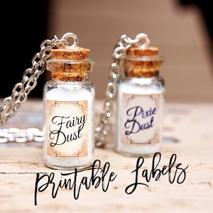 May include: Two small glass bottles with cork stoppers and silver chains, filled with white glitter. The bottles have labels that say "Fairy Dust" and "Pixie Dust". The text "Printable Labels" is written in black cursive below the bottles.