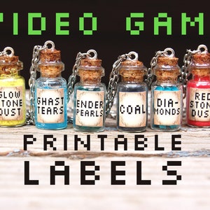 May include: Printable labels for small glass bottles with cork stoppers and silver chains. The labels feature text inspired by video games, such as "Slime", "Glow Stone Dust", "Ghast Tears", "Ender Pearls", "Coal", "Diamond", "Red Stone Dust", and "Gun Powder".