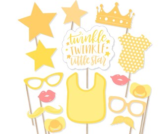 May include: A collection of yellow and peach-colored baby shower photo booth props. Includes stars, glasses, lips, a mustache, a bib, a crown, a baby onesie, and a pacifier. The text "Twinkle Twinkle Little Star" is also included.
