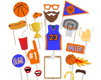May include: A set of 14 basketball-themed photo booth props. The props include a basketball, a basketball hoop, a jersey, a whistle, a trophy, a hot dog, a soda, a beer, a foam finger, a sign that says "Slam Dunk", a sign that says "Baller", a basketball with flames, a mustache, and a headband.