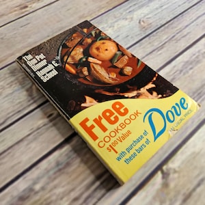 May include: A vintage cookbook titled "The One Pot Dinner" by Hannah G. Scheel. The cover features a pot of stew. The book is yellow and has the word "Free" in large red letters, with the Dove logo.