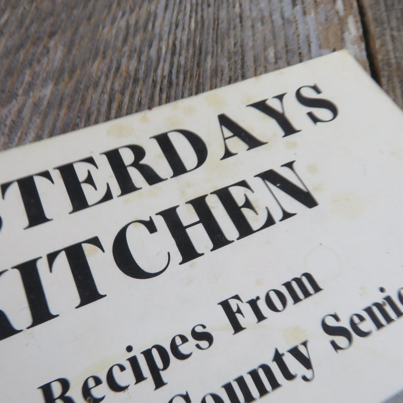 May include: Close-up of a white book cover with the title "Yesterday's Kitchen" in black bold letters. The text "Recipes From County Senior" is also visible in black letters.