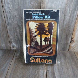 May include: A latch hook pillow kit with a woodland scene design. The kit includes precut rug yarn and is machine washable. The pillow is 12 inches by 17 inches. The kit is made by Sultana, The Quality Line.