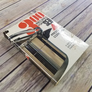 May include: A vintage cookbook titled "300 Recipes for Pressure Cookers" with a red and white design featuring a silver pressure cooker on the cover.