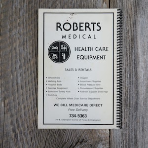 May include: A white and black brochure with the title "Roberts Medical" and the text "Health Care Equipment" in black. The brochure lists medical equipment for sale and rental, including wheelchairs, walking aids, hospital beds, oxygen, and incontinence supplies. The brochure also states that they bill Medicare Direct and offers free delivery. The phone number 734-5363 is listed at the bottom of the brochure.