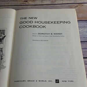 May include: The cover of a vintage cookbook titled "The New Good Housekeeping Cookbook" edited by Dorothy B. Marsh, Director of Foods and Cookery, Good Housekeeping Institute. The book was published by Harcourt, Brace & World, Inc. and features illustrations by Bill Goldsmith.