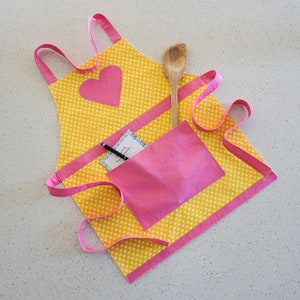 Butterbean’s Cafe Cricket’s Apron, Girls yellow & pink lined apron, Big pink pocket and heart, Girls play craft art cooking apron,