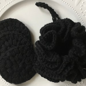 May include: A set of four black crocheted reusable makeup remover pads in a black crocheted drawstring bag.