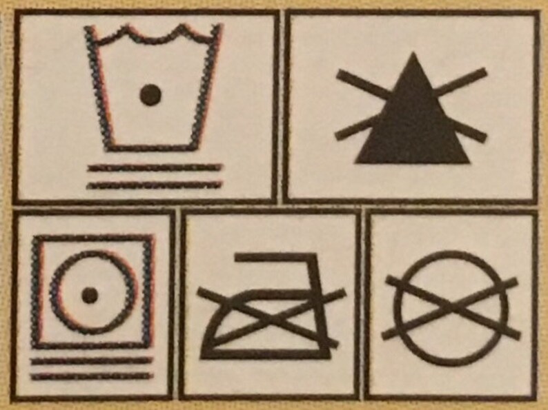May include: A set of four black and white laundry care symbols. The first symbol is a tub of water with three horizontal lines underneath. The second symbol is a triangle with three horizontal lines extending from each side. The third symbol is a circle with a dot in the center and three horizontal lines underneath. The fourth symbol is a crossed-out iron with a horizontal line underneath.