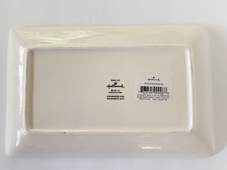 May include: White rectangular ceramic serving tray with a raised rim. The tray has a Hallmark logo and the text "Dishwasher and Microwave Safe" printed on the bottom.