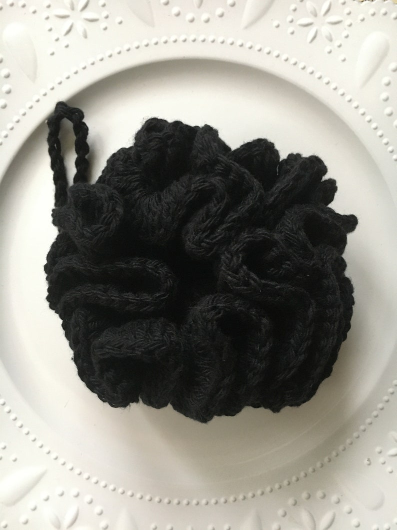 May include: Black crocheted hair scrunchie with a knotted design.