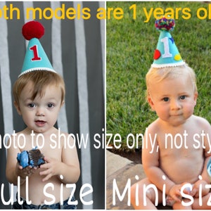 May include: Two images side-by-side showing a baby wearing a blue birthday hat with a red pom-pom and the number 1. The text on the image reads "Both models are 1 years old" and "Photo to show size only, not style". One image is labeled "Full size" and the other "Mini size".