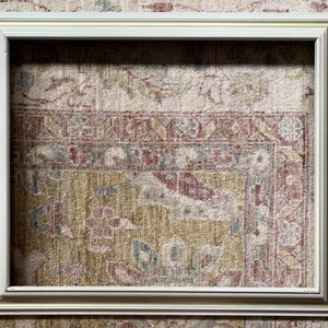 May include: A white picture frame with a simple, clean design. The frame is made of wood and has a smooth finish. It is perfect for displaying photos, artwork, or other decorative items.