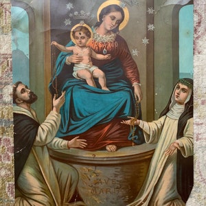 May include: A vintage religious print depicting the Virgin Mary holding a baby Jesus. The image features a blue and red robe, a crown of stars, and a rosary. Two figures, a man and a woman, are kneeling on either side of the Virgin Mary.