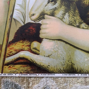 May include: A vintage religious image depicting a young boy holding a lamb in his arms. The boy is wearing a white tunic and has a halo above his head. The image is titled "St. John the Baptist" in English, German, Italian, Spanish, and Portuguese.
