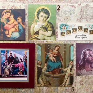 May include: A collection of framed religious prints featuring images of Jesus, Mary, and other biblical figures. The prints are in various styles and colors, including a blue and gold print of the Virgin Mary and Child, a green and brown print of Jesus as a shepherd, and a purple print of Jesus with a halo.