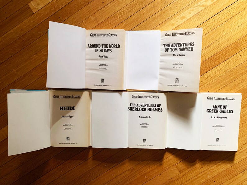 May include: Six classic literature books with white covers and black text. The titles are "Around the World in 80 Days", "The Adventures of Tom Sawyer", "Heidi", "The Adventures of Sherlock Holmes", and "Anne of Green Gables".