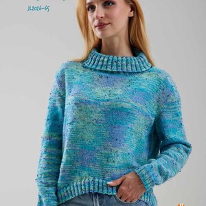 May include: A long-sleeve knit sweater featuring a cowl neck and a variegated color pattern of blue, turquoise, and purple with small dark flecks. The text MANDY JL2026-65 appears in the top left, and the Jody Long Loft Collection logo is in the bottom right.