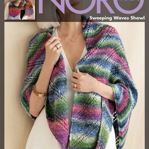 May include: A colorful knitted shawl with a wavy pattern in shades of blue, green, pink, and purple. The shawl is draped over a person's shoulders and is made with a fine yarn. The text "Sweeping Waves Shawl" is visible in the image.