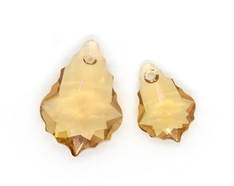 May include: Two teardrop-shaped crystal pendants with a gold tone finish. The larger pendant is about 1.5 inches long and the smaller pendant is about 1 inch long.