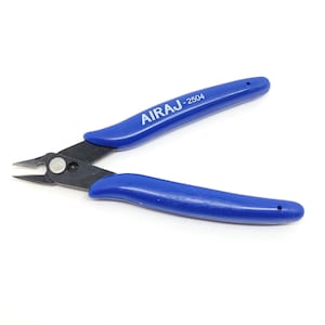 May include: Blue handled wire cutters with the text "AIRAJ - 2504" printed on the handle. The cutting blades are black and the tool is designed for precision cutting. The handles are curved for a comfortable grip.