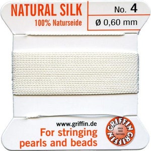 May include: White natural silk thread for stringing pearls and beads. The spool is labeled "Natural Silk" and "No. 4" with a diameter of 0.60 mm. The label also says "100% Naturseide" and "www.griffin.de".