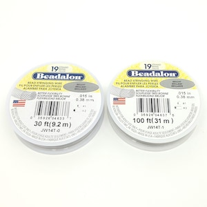 May include: Two spools of Beadalon bead stringing wire. Each spool is labeled with the brand name, wire type, and measurement. One spool contains 30 ft (9.2 m) of wire, and the other contains 100 ft (31 m).