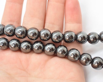 May include: A strand of black hematite beads, each bead is round and smooth with a high polish.
