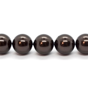 May include: A strand of dark brown round pearls.